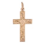 An early 20th century 9ct gold cross pendant. The engraved foliate motif cross, with hook