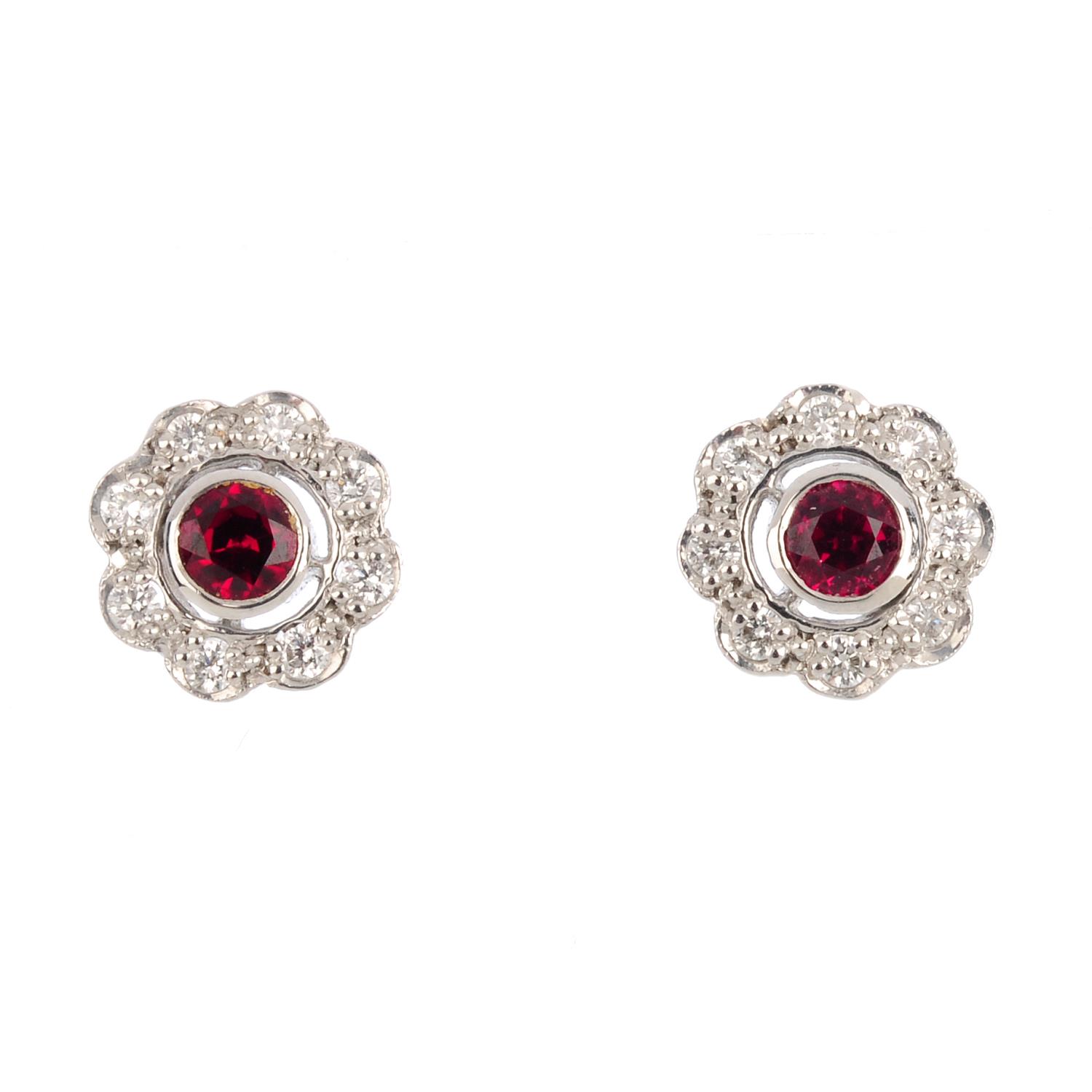 A pair of 18ct gold ruby and diamond cluster earrings. Each designed as a circular-shape ruby and