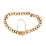 A bracelet. Designed as a curb-link chain, with a grooved box clasp. Length 18cms. Weight 22.8gms.