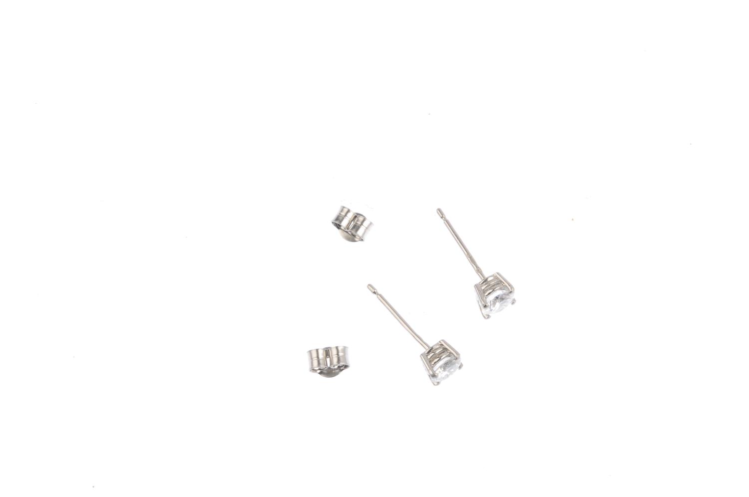 A pair of platinum brilliant-cut diamond stud earrings. Estimated total diamond weight 0.75ct , H- - Image 2 of 2
