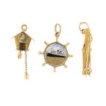 Three charms. To include a 9ct gold polychrome enamel ship wheel charm, a set of skies and poles
