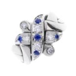 A sapphire and diamond puzzle ring. Designed as four interlocking rings, with brilliant-cut