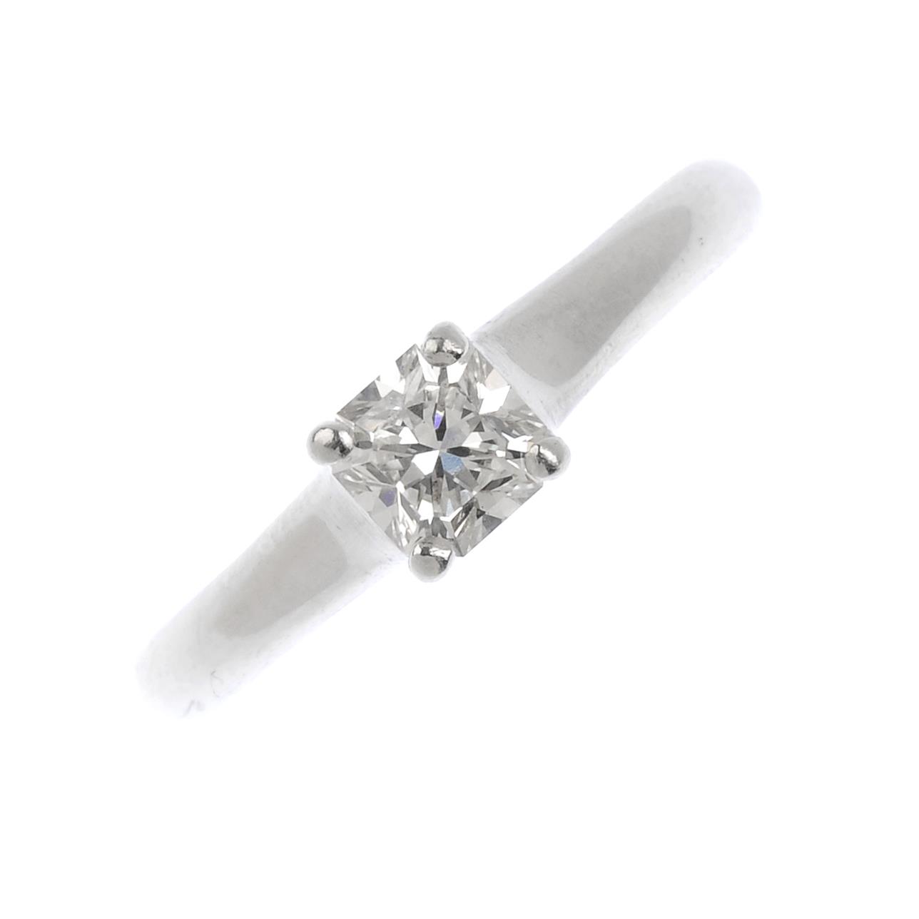 A platinum diamond single-stone ring. The square-cut diamond, with tapered shoulders. Diamond weight