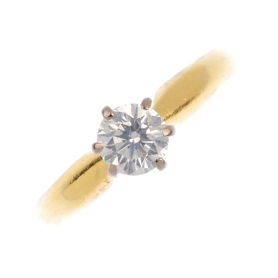 An 18ct gold diamond single-stone ring. The brilliant-cut diamond, with tapered band. Estimated