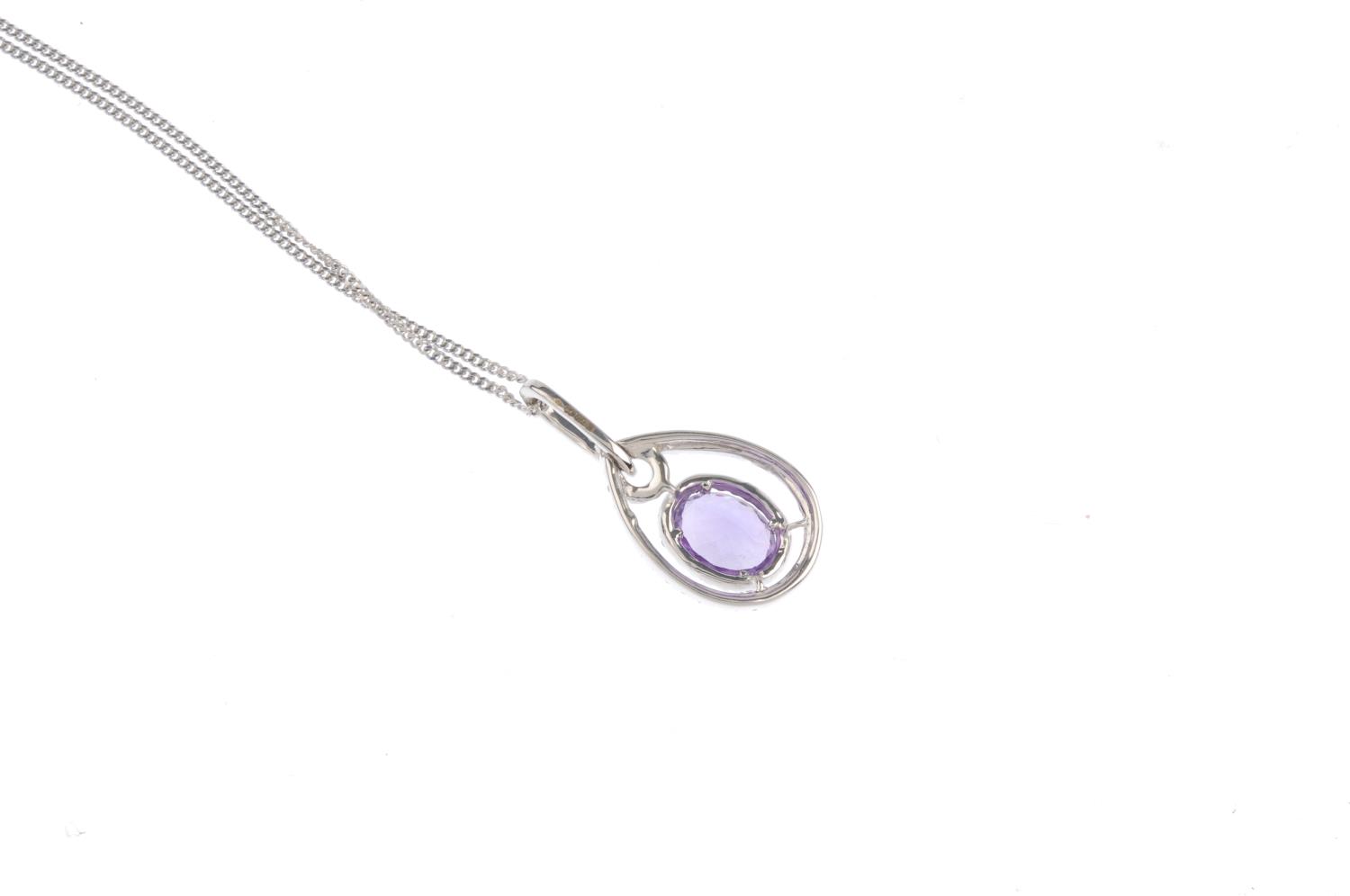 An 18ct gold amethyst and diamond pendant. The oval-shape amethyst and brilliant-cut diamond - Image 2 of 3