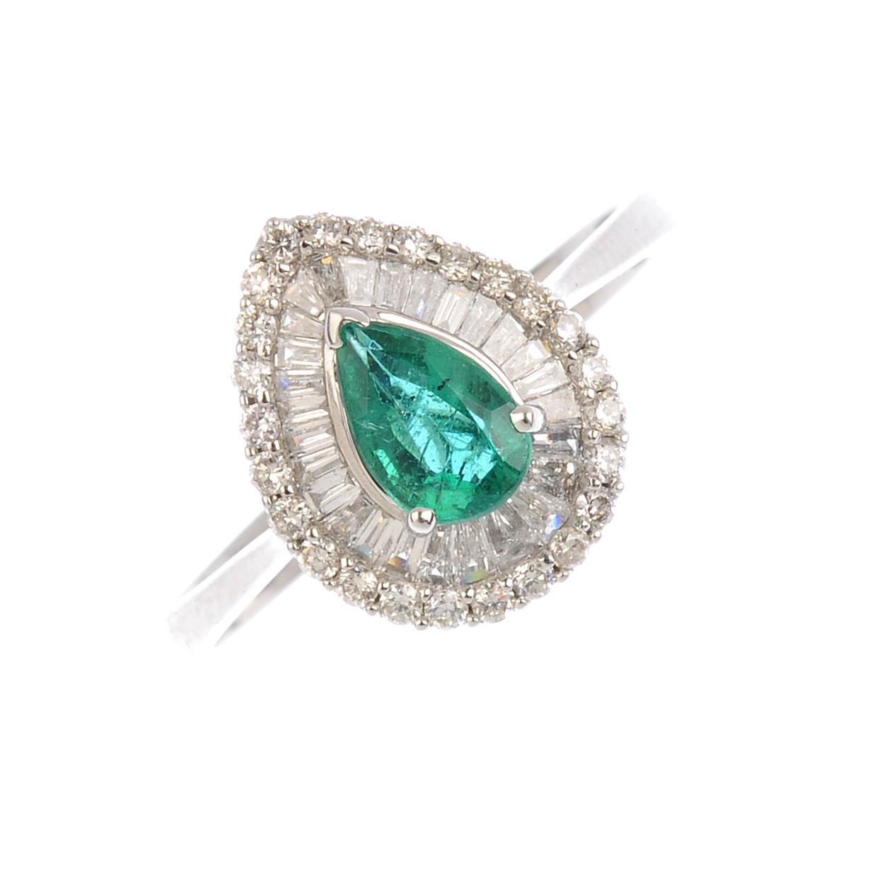 An emerald and diamond cluster ring. The pear-shape emerald, with vari-cut diamond surround. Emerald