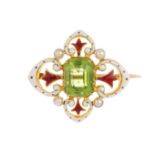 An early 20th century 15ct gold peridot and enamel brooch. The rectangular-shape peridot, within