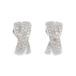 A pair of 18ct gold diamond earrings. Each designed as a pave-set diamond crossover half-hoop. Total