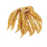 A 1960's 9ct gold foliate brooch. Designed as a foliate spray, with textured scrolling leaves.