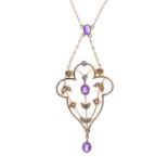 An early 20th century 9ct gold amethyst and split pearl pendant. Of openwork design, the oval-