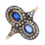 A sapphire and diamond dress ring. Designed as two oval-shape sapphire collet, each within a