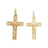 Two crucifix pendants. Each designed as the figure of Christ upon a textured openwork or scrolling