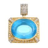 A diamond and paste pendant. Of bi-colour design, the oval-shape blue paste collet, within a