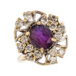 An amethyst and diamond cluster ring. The oval-shape amethyst, with brilliant-cut diamond openwork