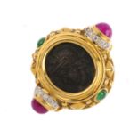 A diamond and gem-set dress ring. The collet mounted oval central panel depicting a Roman Centurion,