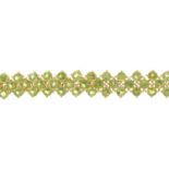 A peridot bracelet. Designed as three rows of circular-shape peridots, with partially concealed