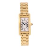 CARTIER - a Tank Americaine bracelet watch. 18ct yellow gold case. Reference 2482, serial