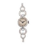 A lady's diamond cocktail watch. The circular dial, with single-cut diamond bezel and vari-cut