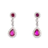 A pair of ruby and diamond earrings. Each designed as a pear-shape ruby and brilliant-cut diamond