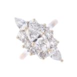 A diamond cluster ring. The marquise-shape diamond, with brilliant-cut diamond surround and pear-