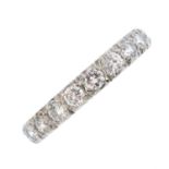 A mid 20th century platinum diamond full eternity ring. The brilliant-cut diamond line, with