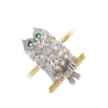 A diamond owl ring. The single-cut diamond owl, with circular-shape emerald eyes, perched upon a