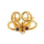 A late Victorian 18ct gold gem-set snake brooch. Designed as two snakes, with cushion-shape ruby