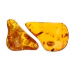 Two pieces of modified amber. The first of pear shape, the second of roughly triangular shape,