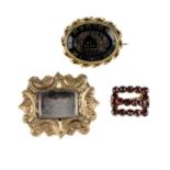 Five late 19th to early 20th century brooches. The first an oval-shape onyx brooch carved to