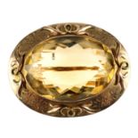 An early 20th century 9ct gold citrine brooch. The oval-shape faceted citrine to the surround with