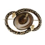 A late Victorian enamel memorial brooch. The oval-shape glazed decorative hair panel, with foliate