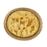 An early 20th century carved ivory brooch. The oval shape ivory panel carved to depict a Chinese