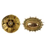 Two late Victorian gold diamond brooches. The first of oval outline, the domed centre with a diamond