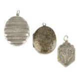 Three late 19th century lockets. The first an oval-shape locket with raised banded detail, floral