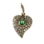 A diamond and emerald heart pendant. Of asymmetric heart shape, the collet-set central circular