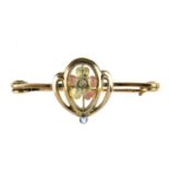 An early 20th century 9ct gold, enamel and seed pearl brooch. The bar brooch with central yellow and