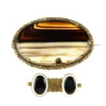 Two late 19th century banded agate brooches. The first of oval outline with scrolling acanthus