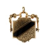 A late 19th century black onyx swivel locket/fob. Of quatrefoil shape, one side inlaid with onyx,