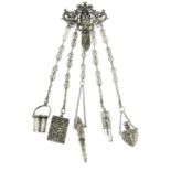 A late Victorian silver chatelaine. The upper section designed as a bearded face, with putti and