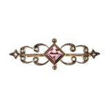 An early 20th century paste and diamond brooch. Of bar design, the diamond-shape purple paste to the