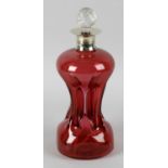 A cranberry glass decanter, the shaped body of pinched form, with applied silver plated collar and