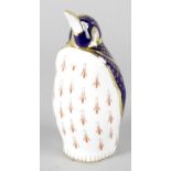 A Royal Crown Derby porcelain paperweight modelled as a penguin, with red printed marks and gold