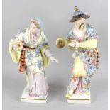 A pair of large German porcelain figurines, the first modelled as a female in elaborate hand painted