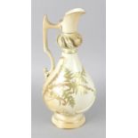 A Royal Worcester bone china ewer, the blush ivory ground decorated with ferns and knopped pierced