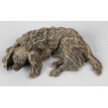A cold painted cast bronze study depicting a resting Spaniel dog, 5.5 (14cm) long. Chips and