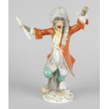 A 20th century Meissen monkey band conductor, modelled with powdered wig, red tail coat, patterned