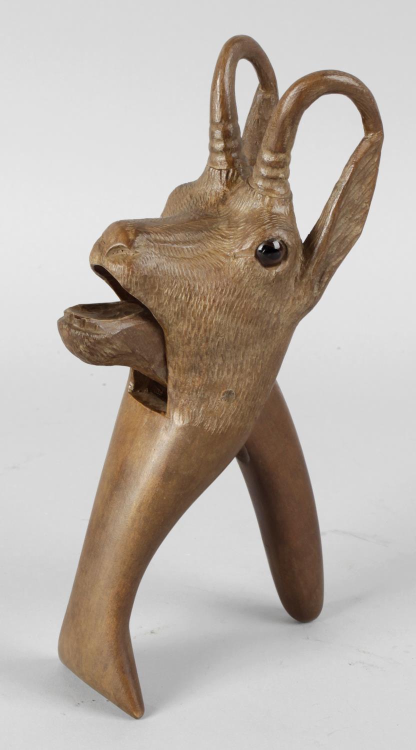 A late 19th century Black Forest carved wooden nutcracker, modelled as the head of a mountain goat