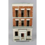 A late 19th century painted wooden dolls house of detached three storey form, the hinged opening