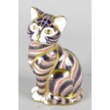 A Royal Crown Derby porcelain paperweight modelled as a seated kitten, with red printed marks and