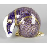 A Royal Crown Derby porcelain paperweight modelled as a badger, with red printed marks and gold